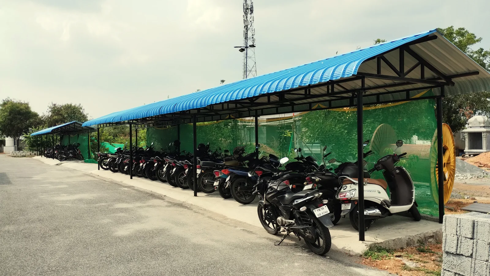 Covered staff parking beside Macrofast's manufacturing unit in Annur, Tamil Nadu, India