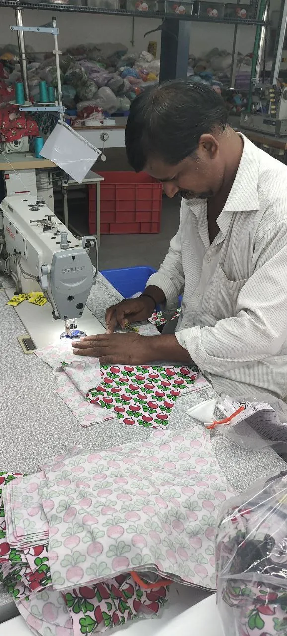 Tailor stitching digitally printed kidswear at Macrofast's Annur garment unit