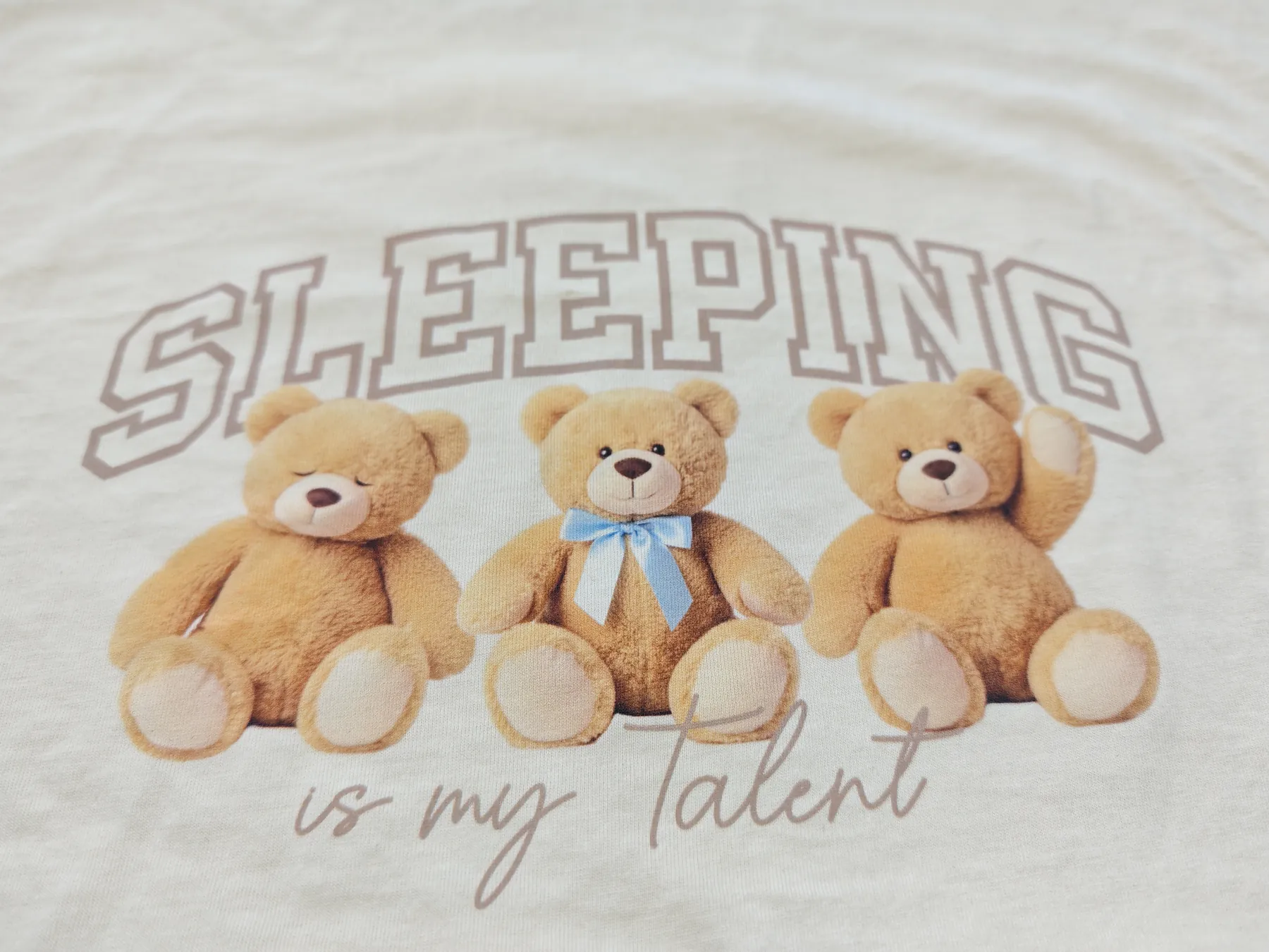 Digital textile print of teddy bears and lettering on kidswear fabric